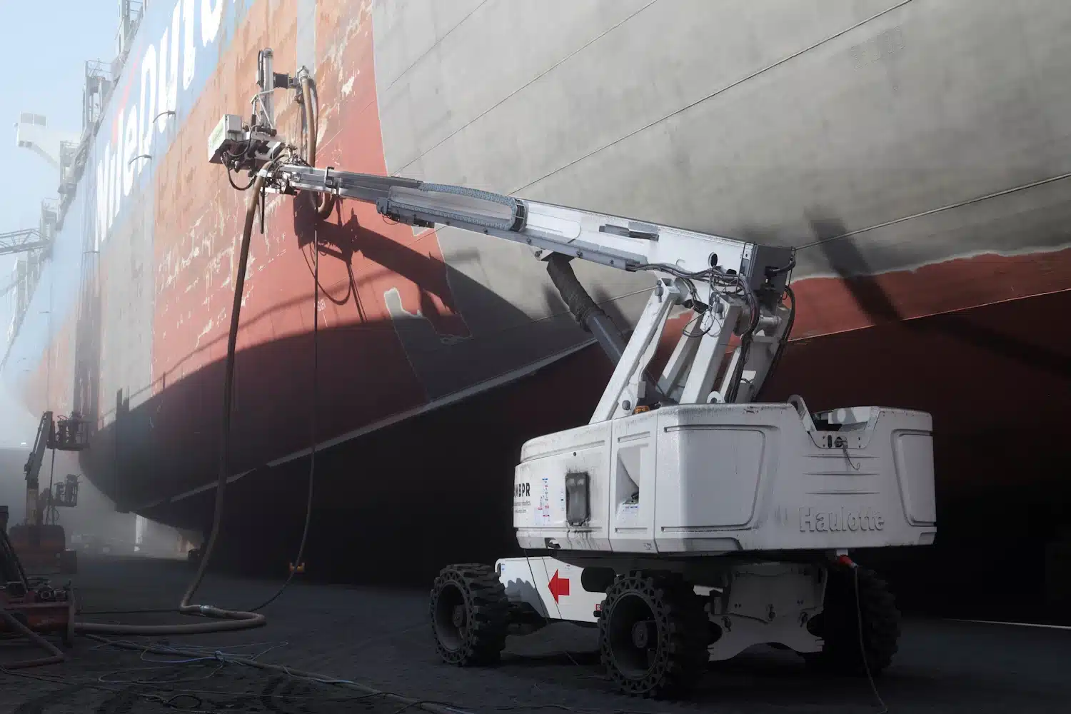 One of the five AMBPR Autonomous Mobile Blast & Paint Robots in action at Damen Shiprepair Dunkerque